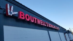 An exterior building sign with "Boutwell's Bowling" in red letters.