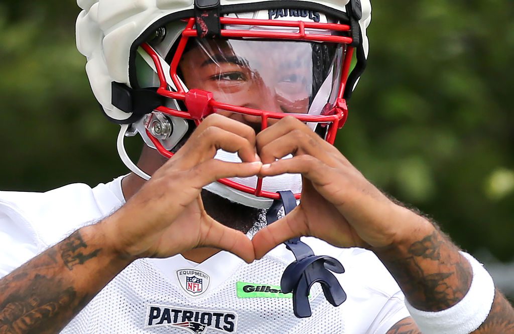 New England Patriots WR Ja'Lynn Polk makes a heart hand during practice.