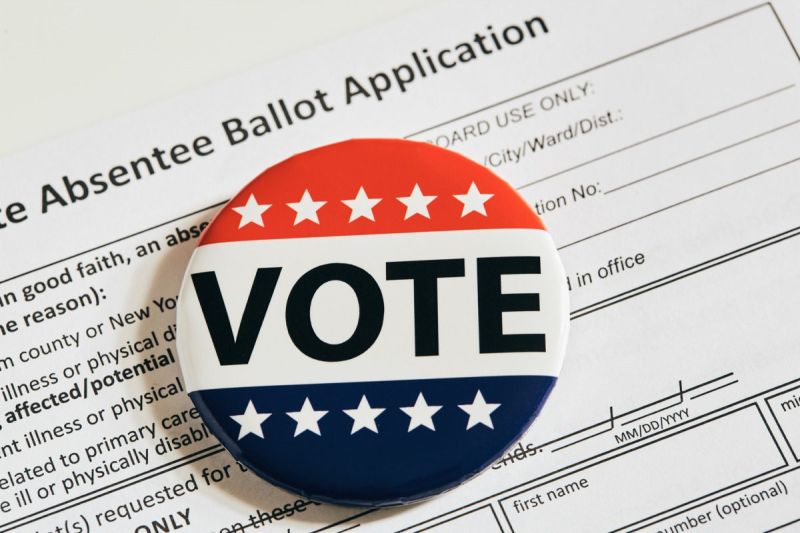 Vote button on top of an absentee ballot.