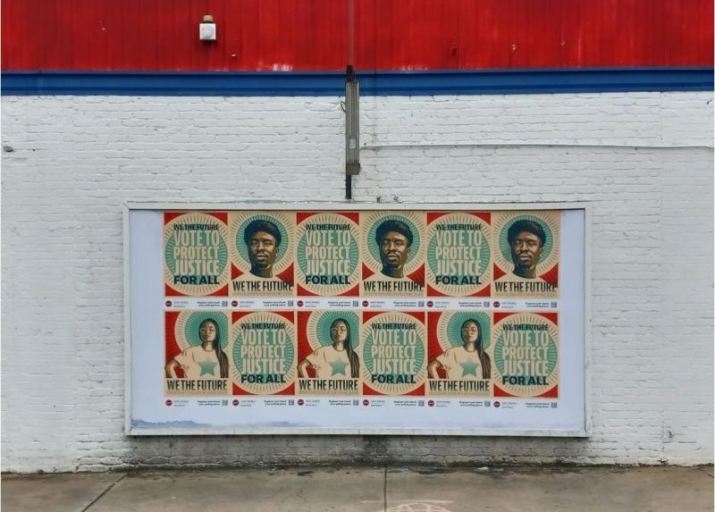 We The Future signs along a street wall.